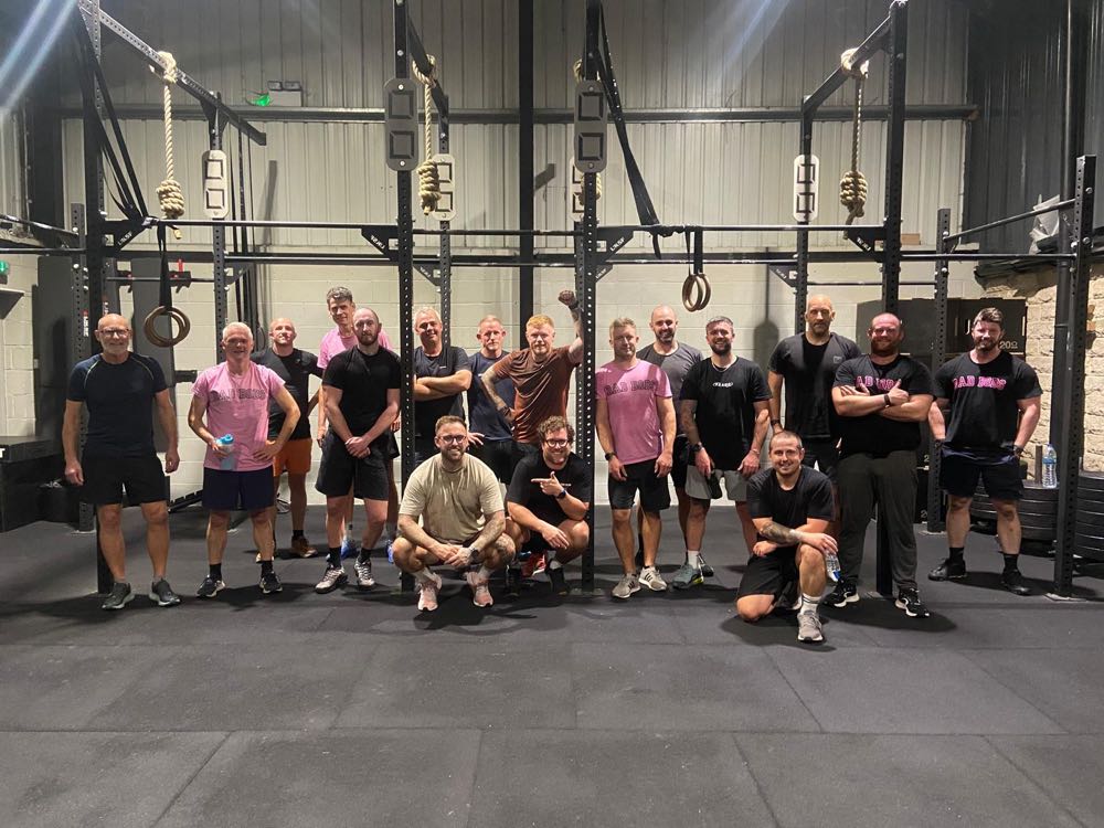 The DadBods group together in the gym after a Monday session