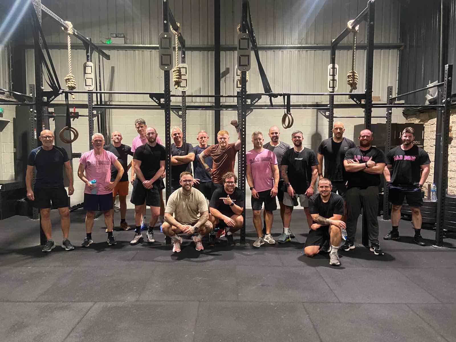 The DadBods group together in the gym after a Monday session